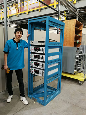 Pedram in front of a rack assembly Pedram